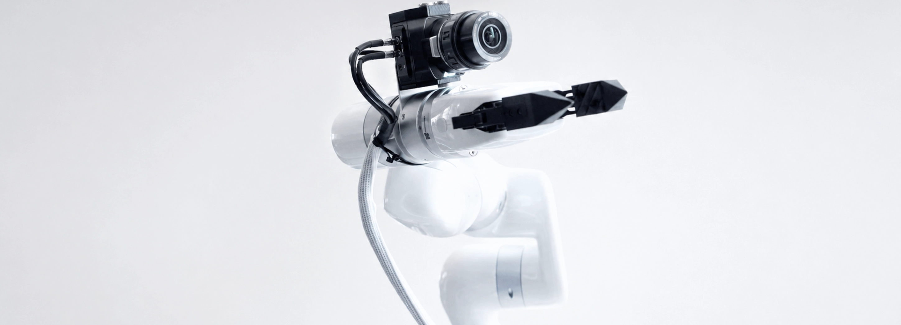 Close-up of a UFACTORY cobot wrist with an industrial camera and gripper