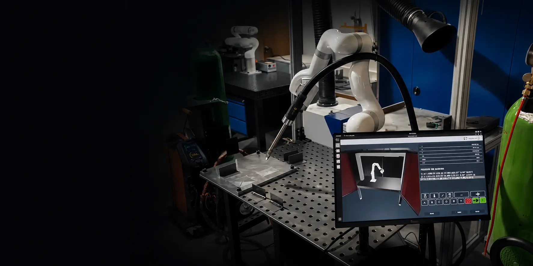 UFACTORY cobot with a welding torch positioned over a fixture table, with a programming interface on screen alongside