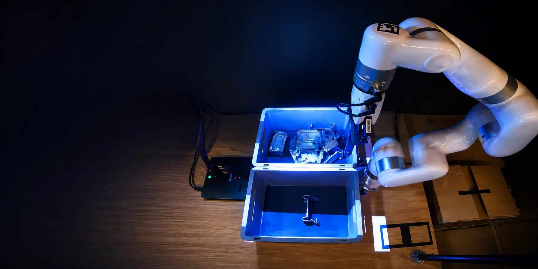 UFACTORY cobot picking a metal bracket from a bin of randomly stacked parts, guided by 3D vision under blue structured light