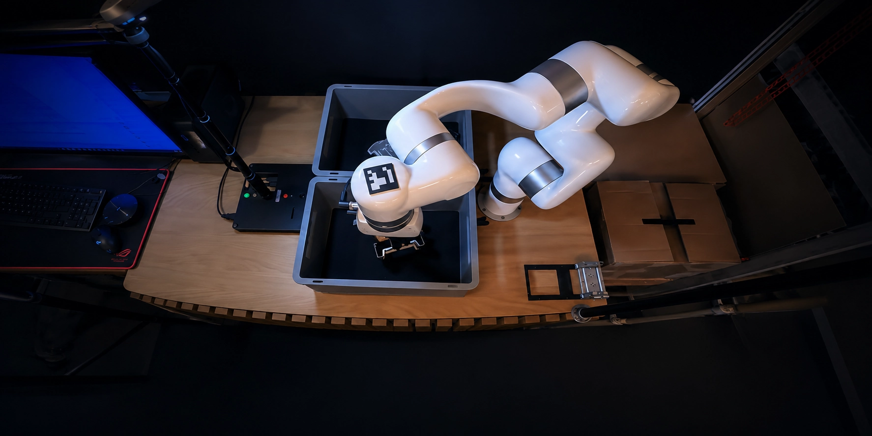 UFACTORY cobot with a gripper reaching into a plastic bin to pick metal parts