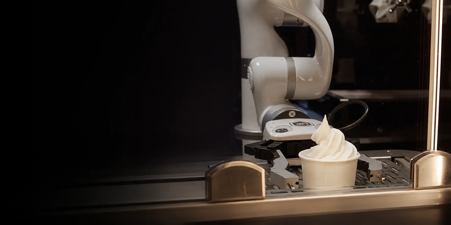 xArm cobot holds a cup of ice cream in an automated dessert serving station