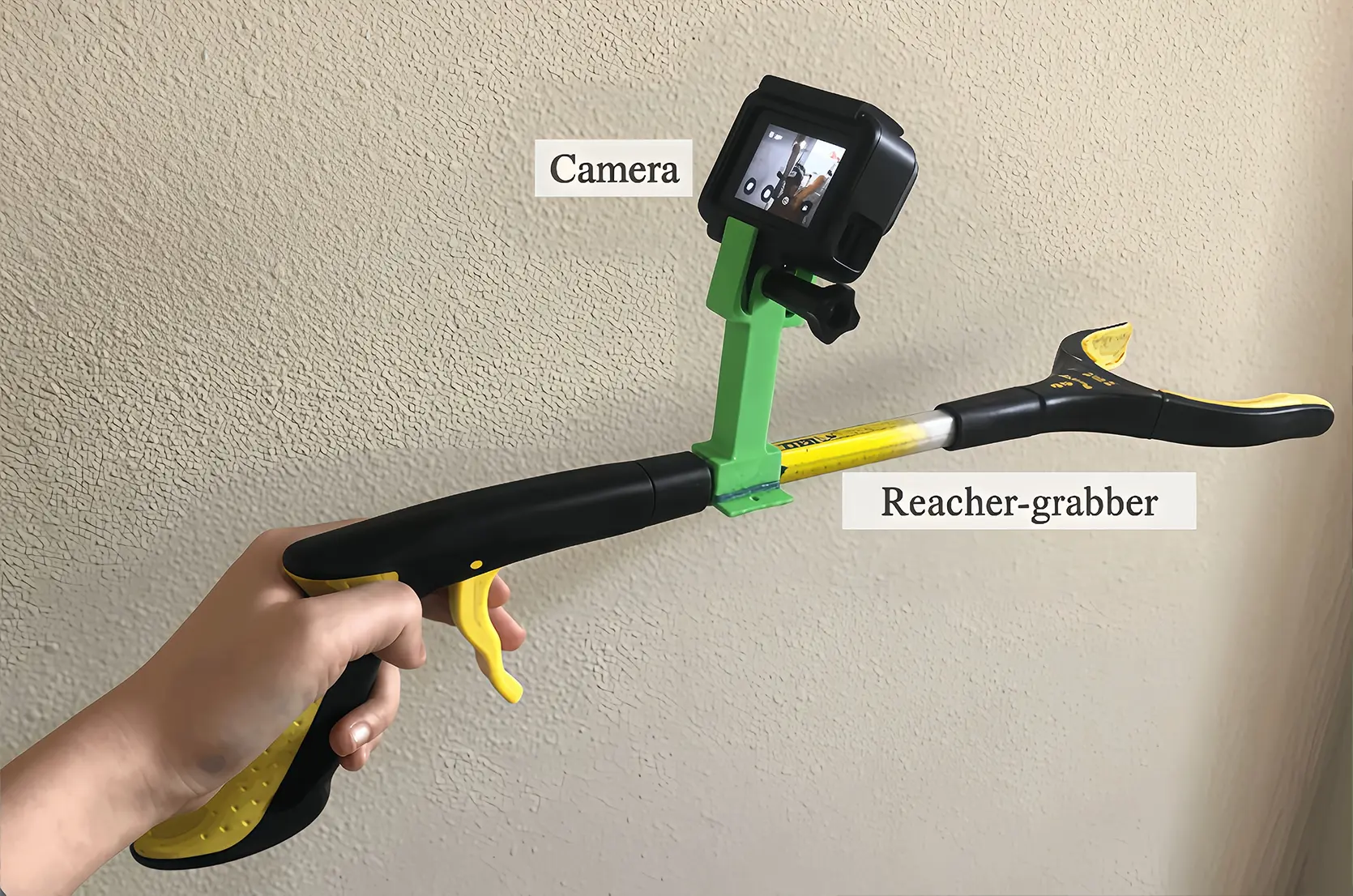 Researchers used a handheld reacher-grabber equipped with a GoPro camera to collect human manipulation demonstrations in real-world environments.