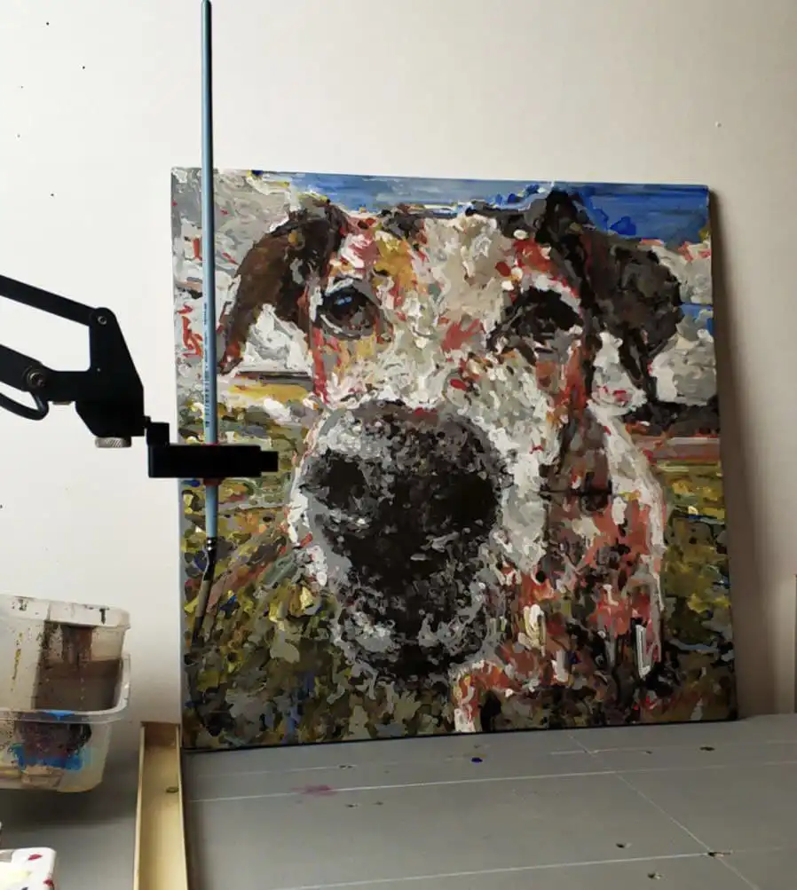 UFACTORY uArm painting robot beside a finished dog portrait