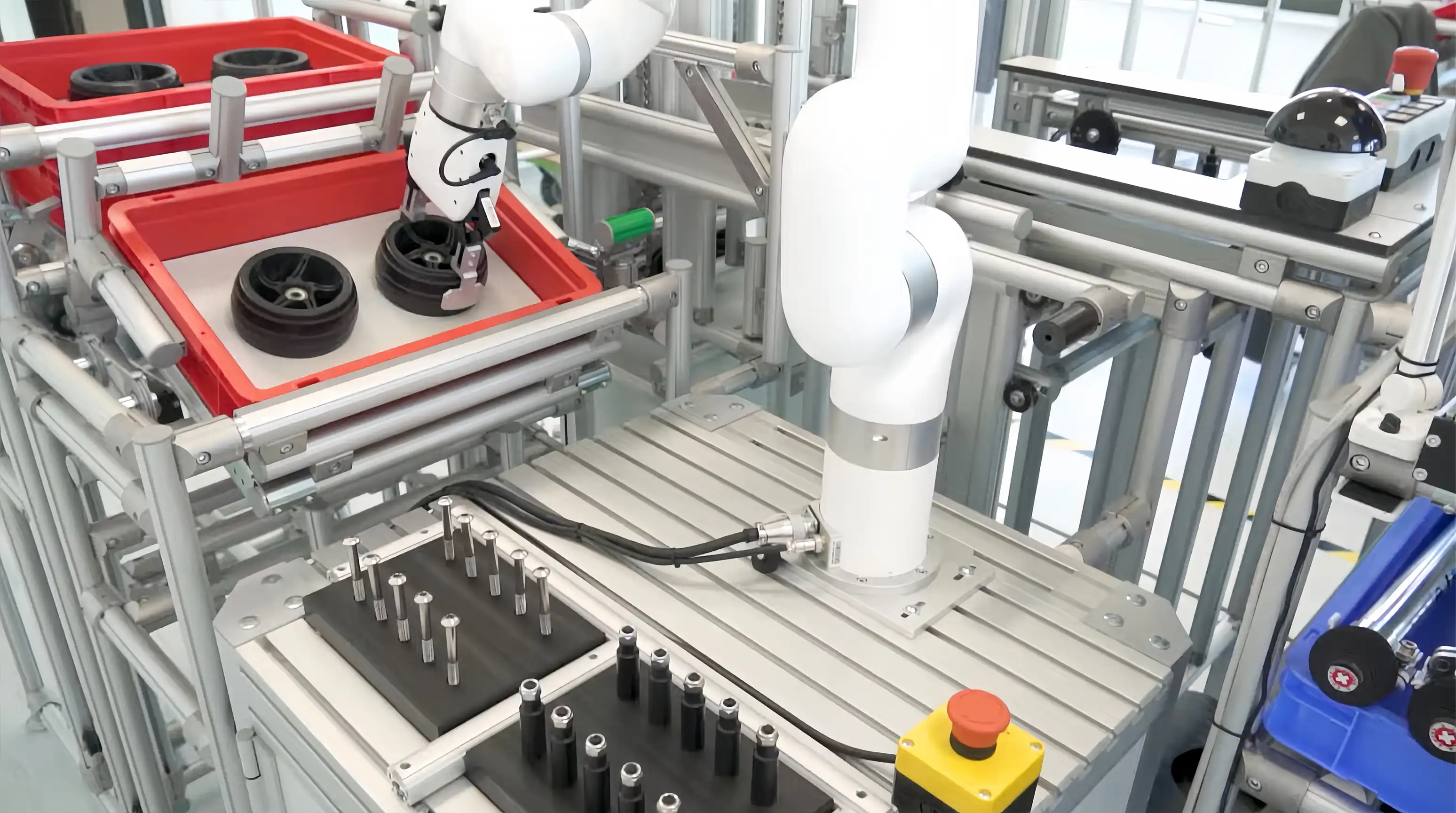 xArm picking up a black wheel from a red bin in a CETPM robotics training workstation